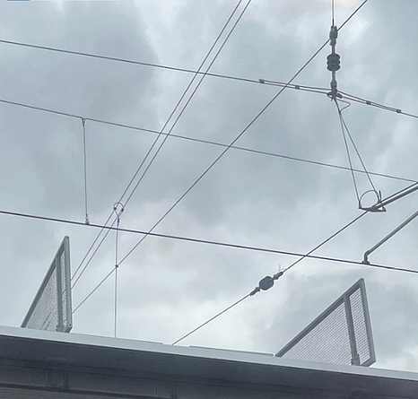 Über dem Bahnsteigdach mit Hindernissen befinden sich Oberleitungen.