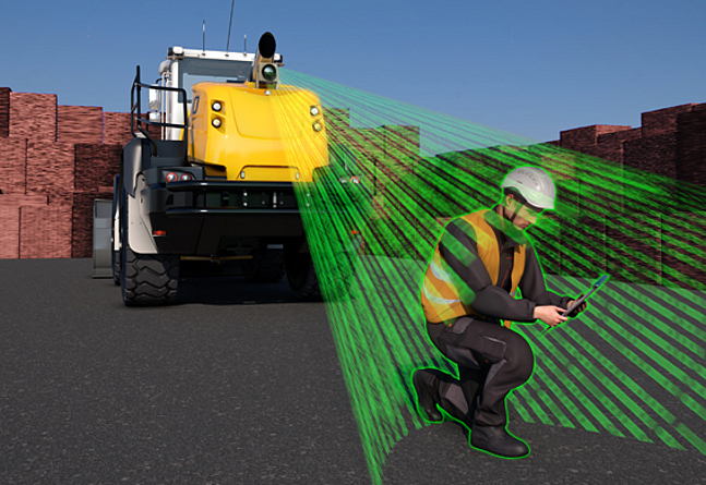 Assistenzsysteme in Baumaschinen können zwischen Menschen und Objekten unterscheiden und damit die Sicherheit der Beschäftigten erhöhen. Eine Kamera ist an einem Baufahrzeug angebracht und erkennt einen hockenden Bauarbeiter vor dem Fahrzeug.