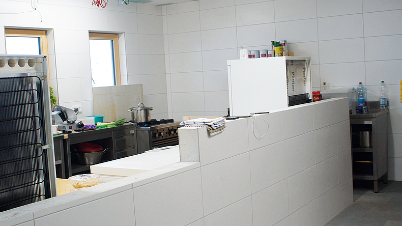 Leicht zu reinigen: In der Küche fiel die Entscheidung auf eine weiße Fliese mit rechteckigem Format. Blick auf einen Teil der neu gefliesten Küche. Verwendet wurden große, rechteckige weiße Fliesen.